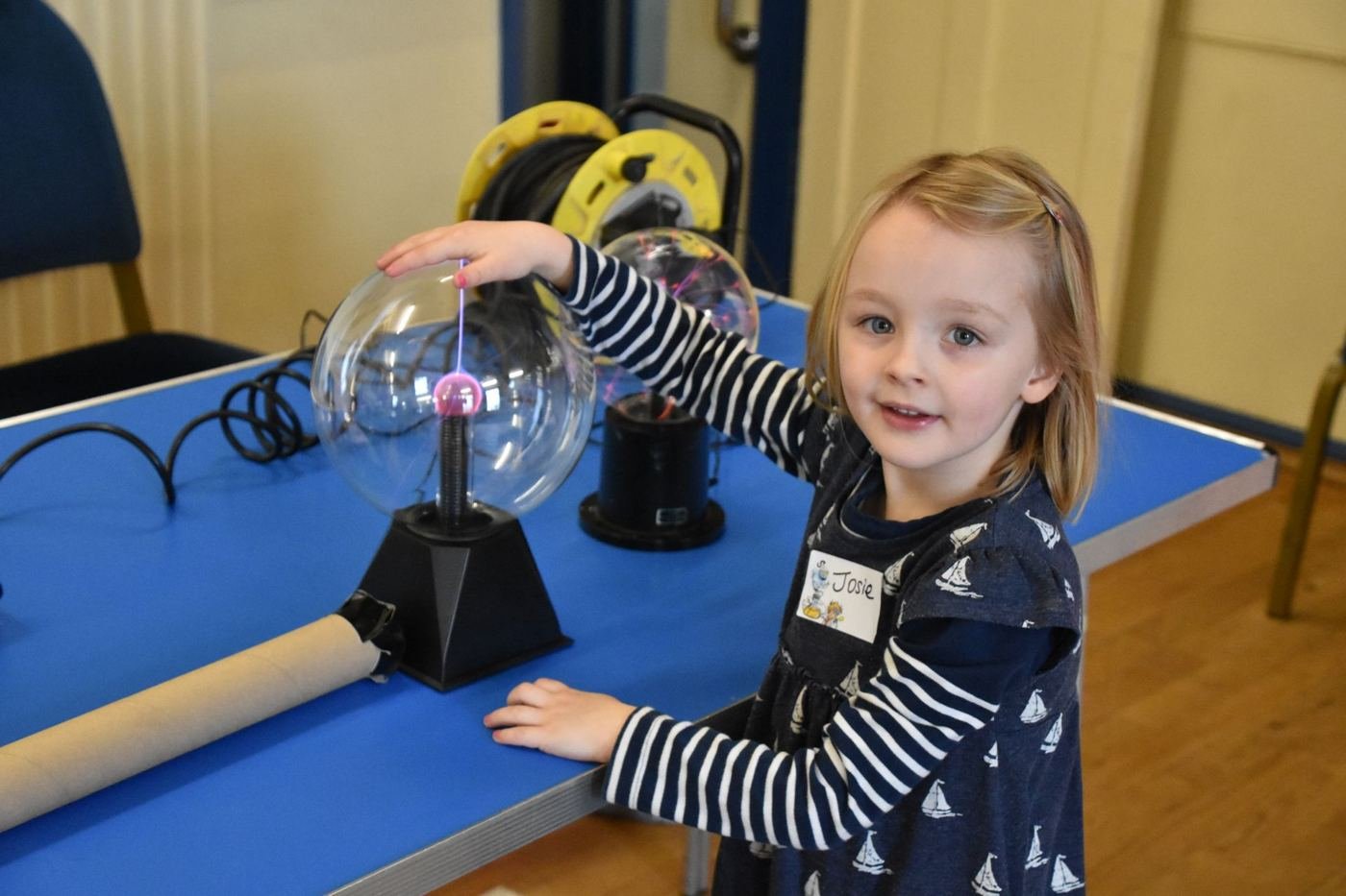 Child touching a plasma ball